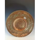 AN ARTS AND CRAFTS COPPER DISH WORKED WITH A BAND OF LEOPARDS WALKING AROUND THE DISHED CENTRE. Dia.