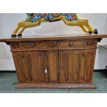 A CONTINENTAL WALNUT DRESSER, THE RECTANGULAR TOP OVER TWO DOORS EACH WITH TWO PANELS