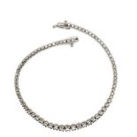 A HALLMARKED 18ct WHITE GOLD GRADUATED LINE BRACELET. LENGTH 20cms. WEIGHT 7.58grms.