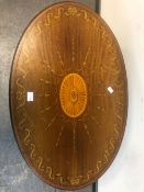 A MARQUETRIED MAHOGANY OVAL TABLE, THE CENTRAL PATERA TO THE TOP ENCLOSED BY RADIATING HUSKS WITHIN