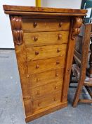 A 19th C. CEDAR WELLINGTON CHEST, THE FIVE DRAWERS AND CUPBOARD BELOW LOCKING BY A HINGED PILASTER