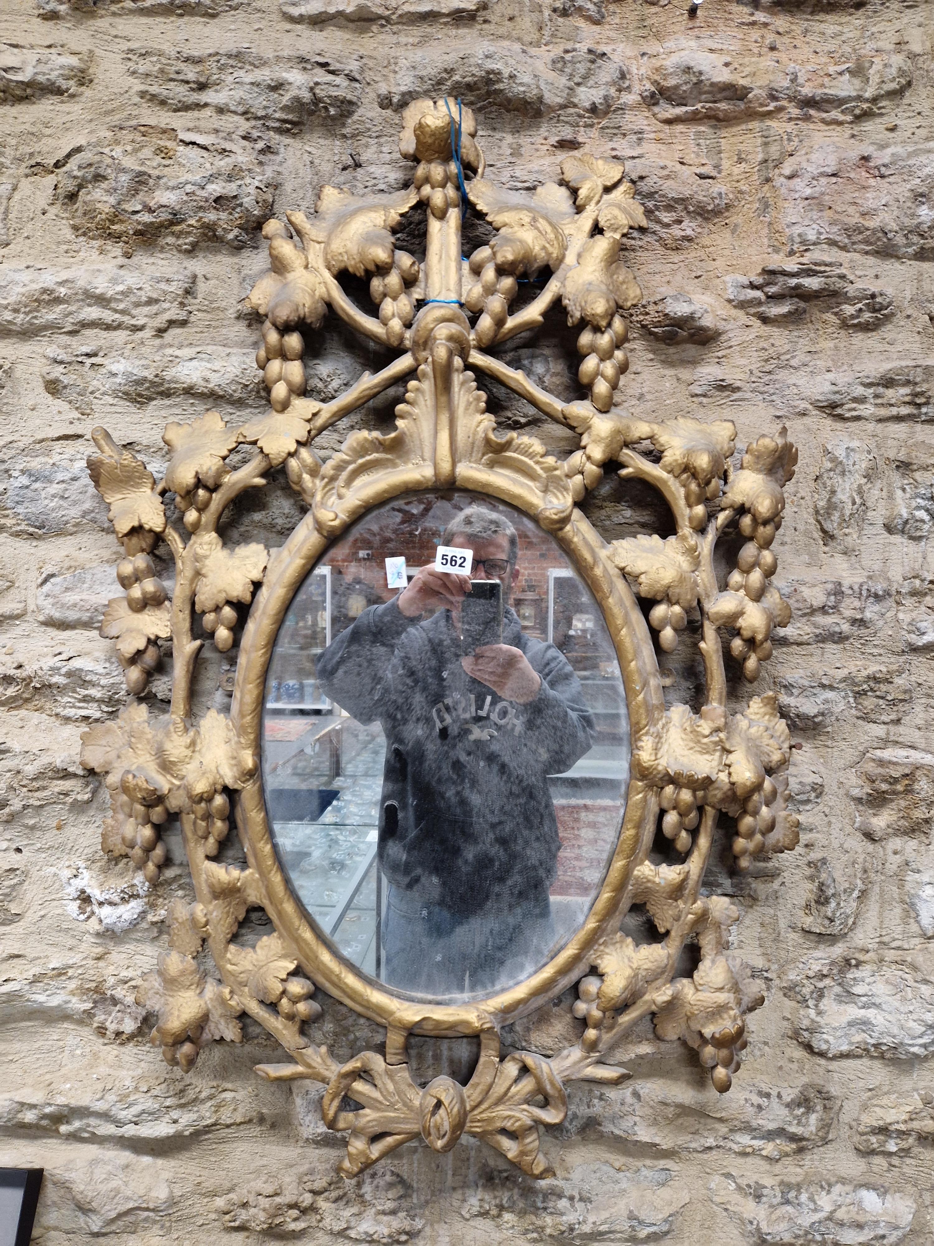 AN OVAL MIRROR IN A LATE 18th C. GILT FRAME PIERCED AND CARVED WITH GRAPE VINES. 95 x 64cms. - Image 11 of 12