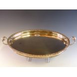 A EUROPEAN TWO HANDLED OVAL TRAY WITH A FLOWER HEAD CAST RIM BAND AND A MAHOGANY BASE, TWO MARKS