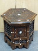AN ISLAMIC HEXAGONAL TABLE, THE CENTRAL STAR INLAID IN THE TOP ENCLOSED BY BLIND FRET SCRIPT,