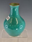 ATTRIBUTED TO INABA, A MUSEN ENAMEL BOTTLE VASE WORKED WITH A BAND OF FLOWERS ON A GREEN GROUND. H