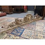 A VICTORIAN PIERCED AND CARVED GILT WOOD PELMET WORKED WITH FRUIT AND FOLIAGE ABOUT THE CENTRAL