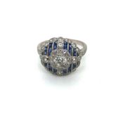 AN ART DECO STYLE SAPPHIRE AND DIAMOND RING. UNHALLMARKED, STAMPED PLAT, ASSESSED AS PLATINUM.