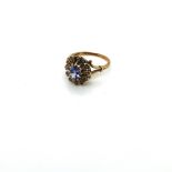 A 9ct HALLMARKED GOLD GEMSET RING IN AN OVAL CLUSTER STYLE. FINGER SIZE P. WEIGHT 3.52grms.