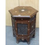 AN ISLAMIC HEXAGONAL TABLE CARVED WITH BLIND FRET FOLIAGE DIAMONDS, TRIANGLES AND BANDS ABOUT MOTHER