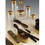 FOUR EARLY 20th C. NINE CARAT GOLD TOPPED DRESSING TABLE BOTTLES AND A HIP FLASK BY J C VICKERY,