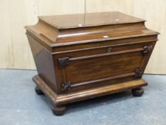 A REGENCY MAHOGANY CELLARETTE, THE RECTANGULAR LID ABOVE SIDES TAPERING TO A PLINTH AND BUN FEET.