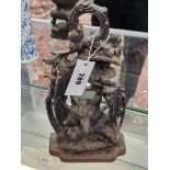 A CAST IRON DOOR STOP WITH A FOX PEERING OVER HUNTING BOOTS BELOW A GRAPE VINE. H 30cms.