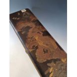 A JAPANESE BLACK LACQUER SCROLL BOX, THE COVER WORKED WITH AN EAGLE PERCHED IN A PINE TREE BELOW