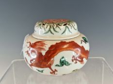 AN ARITA POLYCHROME INCENSE JAR AND COVER, THE BUN SHAPED BODY PAINTED WITH AN IRON RED DRAGON