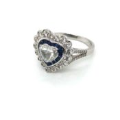 A SAPPHIRE AND DIAMOND HEART SHAPE CLUSTER RING. THE CENTRAL DIAMOND A FANCY CUT SURROUNDED BY A