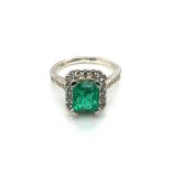A PLATINUM HALLMARKED EMERALD AND DIAMOND RING. THE EMERALD MEASUREMENTS 8.4 X 6.7mm. FINGER SIZE M.