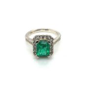 A PLATINUM HALLMARKED EMERALD AND DIAMOND RING. THE EMERALD MEASUREMENTS 8.4 X 6.7mm. FINGER SIZE M.