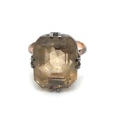 A VINTAGE GEMSET COCKTAIL RING. THE RAISED SETTNG WITH DEEP RECTANGULAR FACET GEMSTONE. UNHALLMARKED