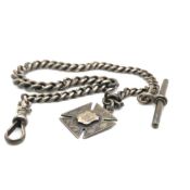 A HALLMARKED SILVER GRADUATED CURB ALBERT CHAIN, COMPLETE WITH T-BAR AND FOB. LENGTH 35cms. WEIGHT