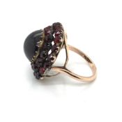 AN ANTIQUE VICTORIAN BOHEMIAN GARNET RING CONVERTED FROM A BROOCH. ASSESSED AS SILVER ALLOY AND