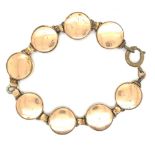 A VINTAGE GOLD PLATED PANEL BRACELET EACH WITH A SPORTING PRINT. LENGTH 18cms.