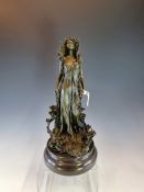 A COLD CAST BRONZE FIGURE OF AN ART NOUVEAU LADY STANDING AMONGST AND DRAPED WITH LILIES, HER EYES C