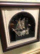 A FRAMED 925 SILVER TWO MASTED OMANI DOW WITH BOTH SAILS UP, THE DIORAMA WITHIN A ROUND ARCHED MOUN