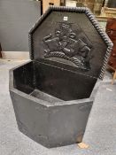 AN PAINTED PINE CISTERN/ LOG BOX WITH THE FACETED BOW FRONT BACKED BY A BOARD CARVED IN RELIEF WITH