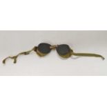 Pair of 20th century military wool lined green glass tinted motorcycle/dust goggles (a/f), strap has