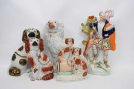 Group of Staffordshire wares including two dogs, one seated on a barrel, further dogs and figure