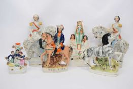 Group of Staffordshire models including one of a zebra, Tom King and two military figures on