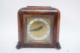 Small Art Deco period Elliott mantel clock set in a walnut veneered case, the face bearing retailers