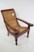 Far Eastern hardwood tea planters chair with caned back and seat, raised on turned front legs,