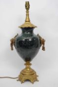 Lamp with gilt scrolling design to base to lion mask handles and onyx reservoir with gilt lamp