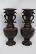 Pair of Chinese bronze altar vases decorated in relief with flowers and birds, 33cm high (2)