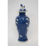 Chinese porcelain vase, blue ground with prunus decoration with matching cover, 27cm high