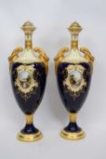 Pair of Coalport vases, the blue ground with gilt central cartouche of lakeside scenes with