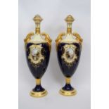 Pair of Coalport vases, the blue ground with gilt central cartouche of lakeside scenes with