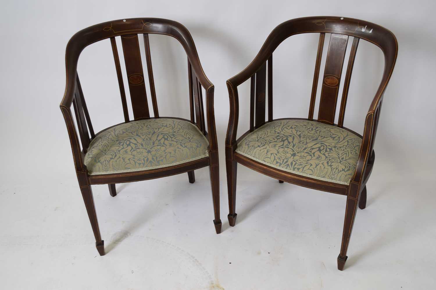 Pair of Edwardian mahogany framed bow back side chairs with blue floral upholstered seats, set on
