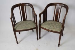 Pair of Edwardian mahogany framed bow back side chairs with blue floral upholstered seats, set on