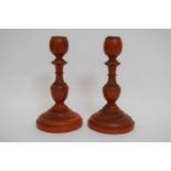 Pair of late 19th century Chinese wooden carved candlesticks, painted in cinnabar style, 17cm