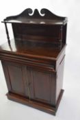 Small 19th century mahogany chiffonier with broken arch pediment over a single shelf, the body