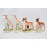 Pair of Staffordshire greyhounds with rabbits and further pair seated on their haunches (4)