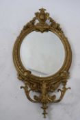 19th century girandole wall mirror with bevelled plate surrounded by a gilt frame with floral