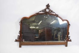 Victorian arch top mahogany framed mirror decorated with applied carved detail, 150cm wide