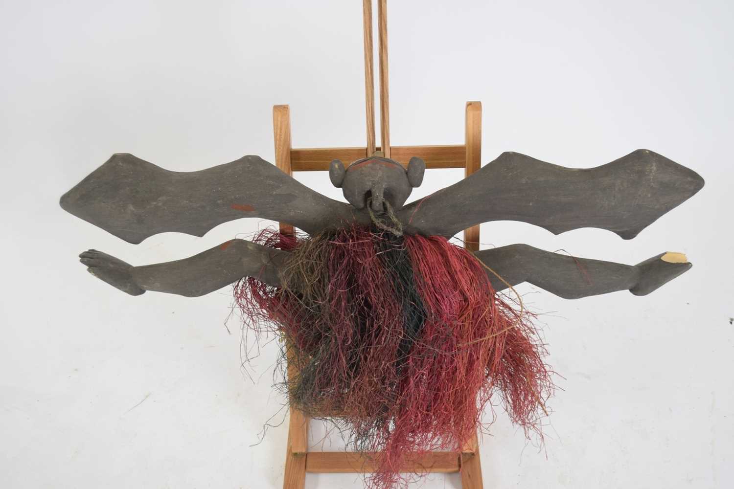 Tribal/ethnographica interest - Papua New Guinea painted wooden bat wall hanging with fibre skirt, - Image 2 of 3