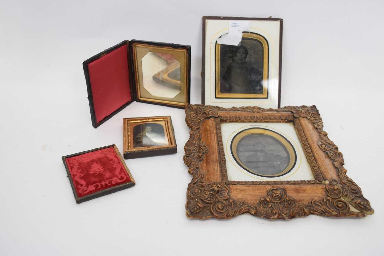 Group of four Victorian photographs including one Daguerrotype two in leather frames, one in a