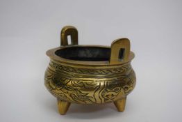 Small Chinese brass censer on three stub feet, 12cm diam