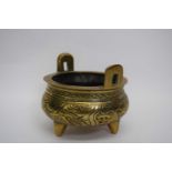 Small Chinese brass censer on three stub feet, 12cm diam