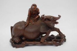 Chinese carving of a buffalo with man astride on carved wooden base